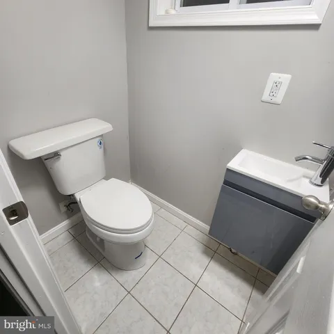a white toilet sitting next to a sink