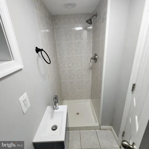 a bathroom with a sink a mirror and shower