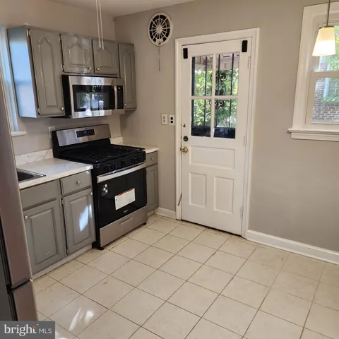a kitchen with a stove a sink and a microwave