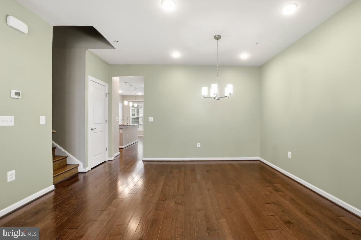 23517 Public House Road, Unit H Clarksburg, MD 20871 - Photo 11 of 49 a view of an empty room with wooden floor and a window