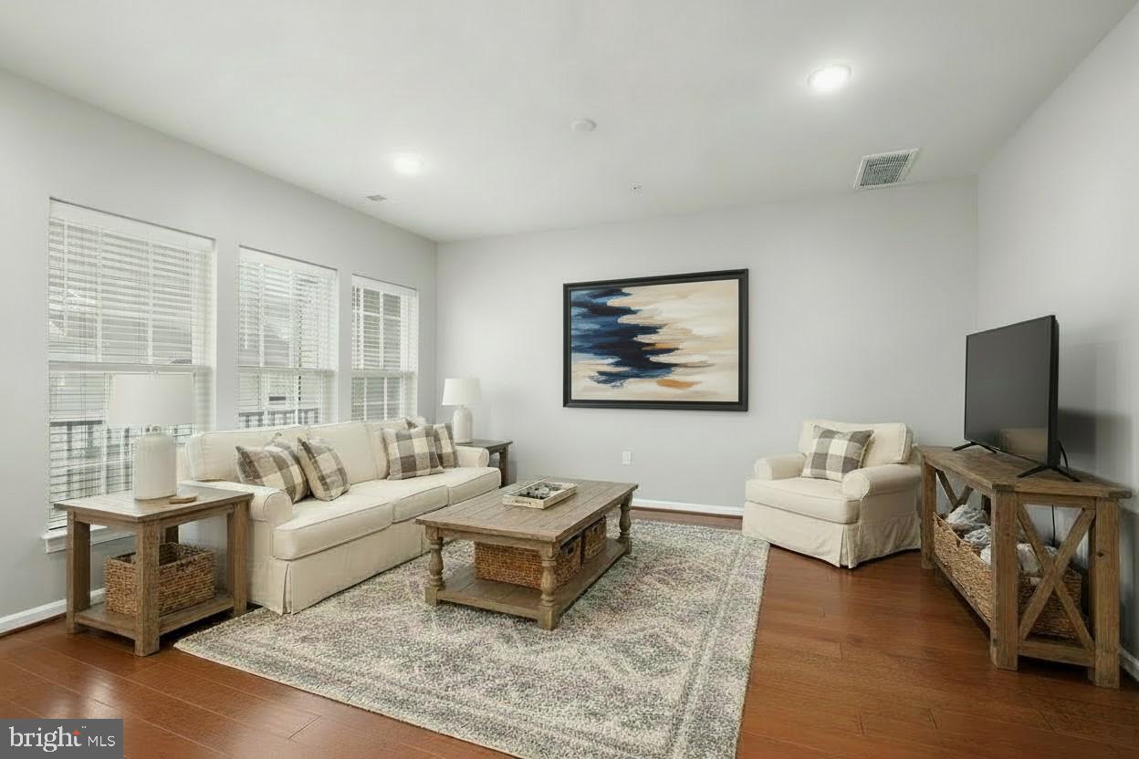23517 Public House Road, Unit H Clarksburg, MD 20871 - Photo 16 of 49 a living room with furniture and a flat screen tv