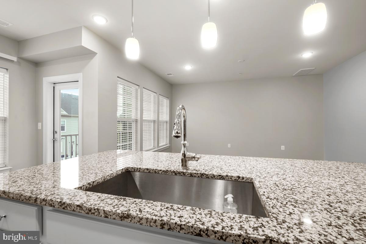23517 Public House Road, Unit H Clarksburg, MD 20871 - Photo 21 of 49 a kitchen with kitchen island a sink and a window