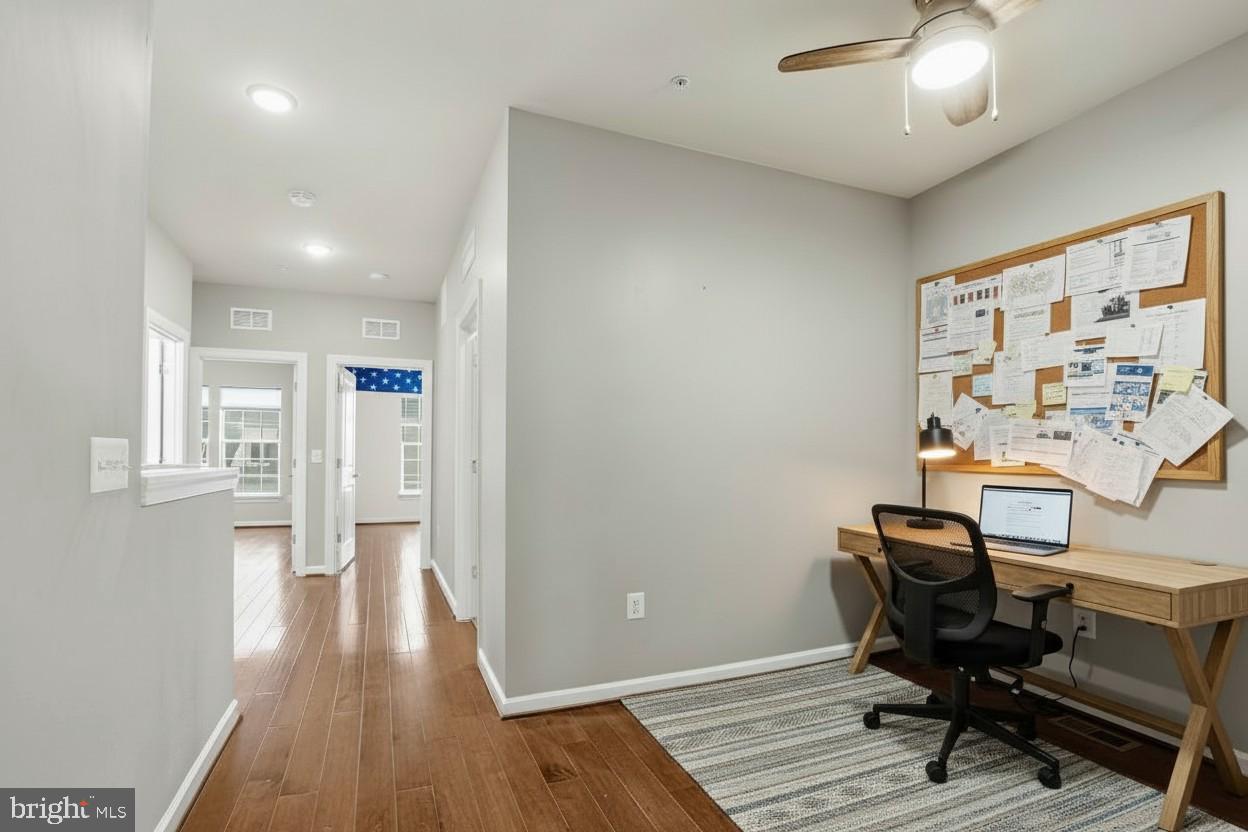 23517 Public House Road, Unit H Clarksburg, MD 20871 - Photo 29 of 49 a view of a workspace with furniture and wooden floor
