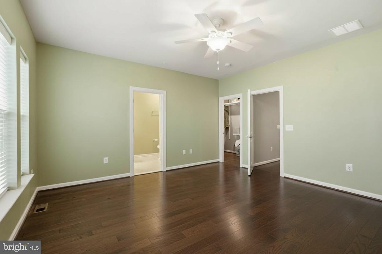 23517 Public House Road, Unit H Clarksburg, MD 20871 - Photo 32 of 49 an empty room with wooden floor and windows