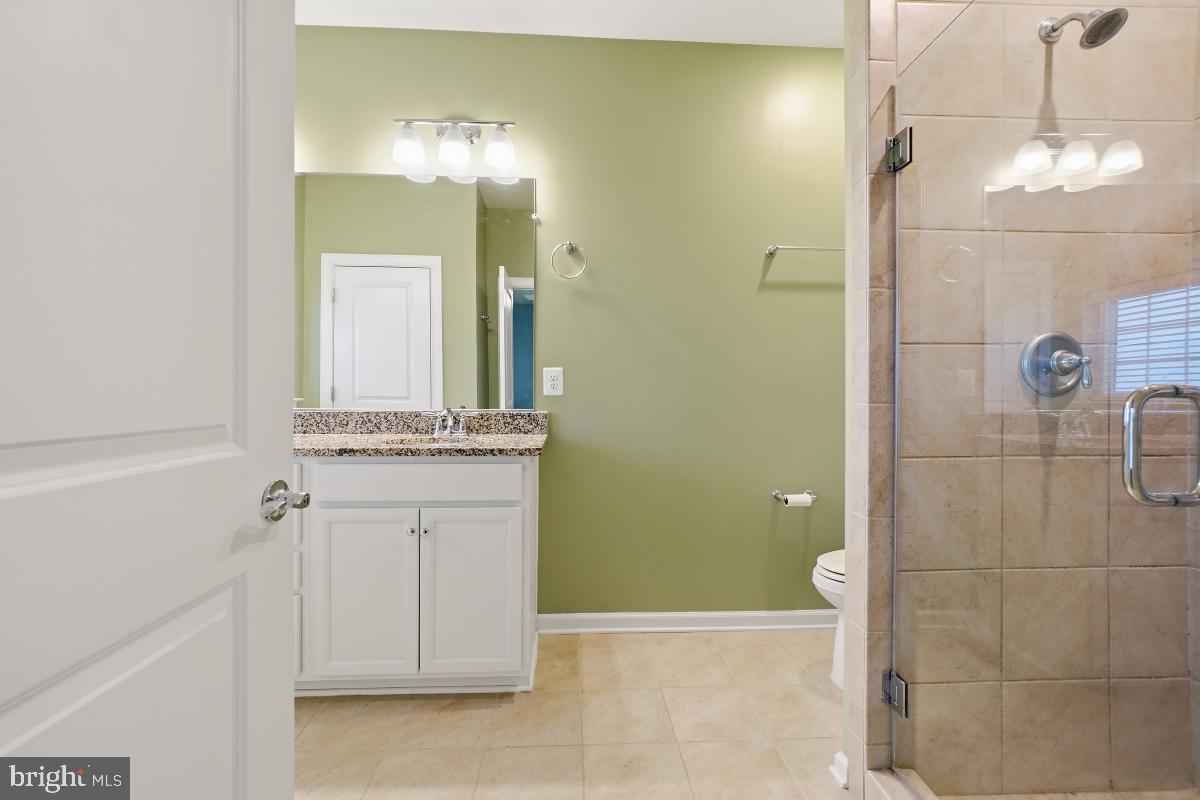 23517 Public House Road, Unit H Clarksburg, MD 20871 - Photo 33 of 49 a bathroom with a double vanity sink mirror and shower