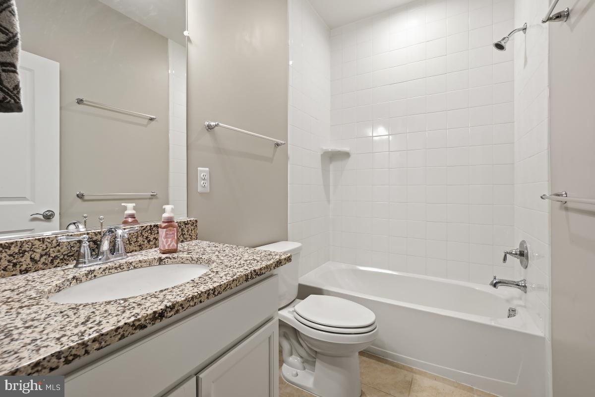 23517 Public House Road, Unit H Clarksburg, MD 20871 - Photo 40 of 49 a bathroom with a granite countertop sink a toilet and bathtub