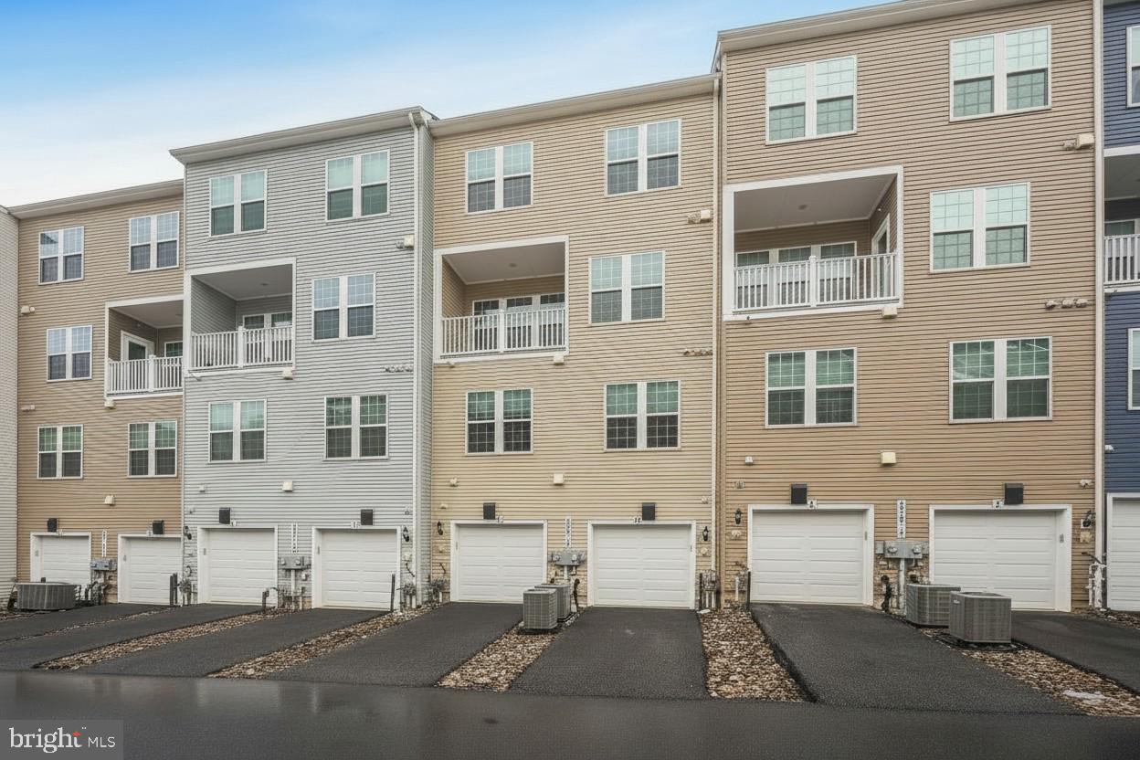 23517 Public House Road, Unit H Clarksburg, MD 20871 - Photo 46 of 49 a front view of a building with a street