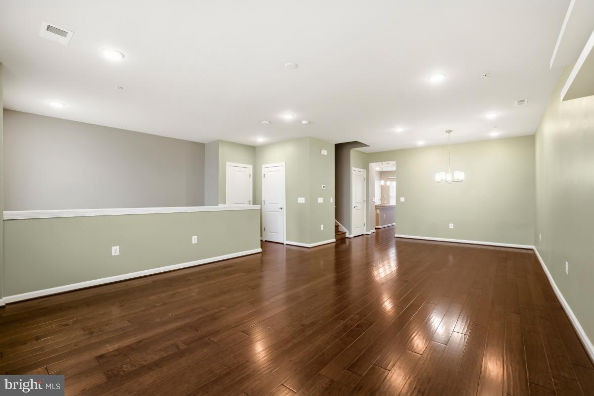 23517 Public House Road, Unit H Clarksburg, MD 20871 - Photo 7 of 49 a view of an empty room with wooden floor