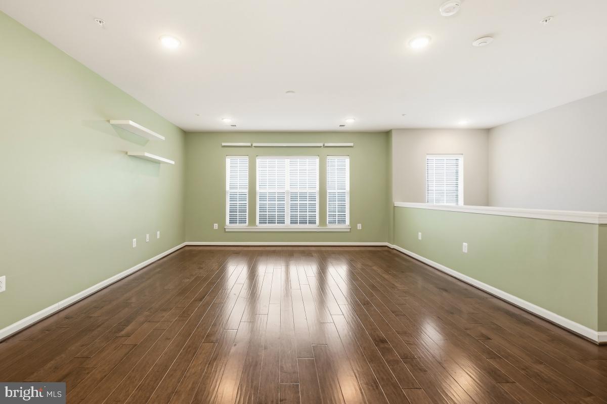 23517 Public House Road, Unit H Clarksburg, MD 20871 - Photo 9 of 49 an empty room with wooden floor and windows