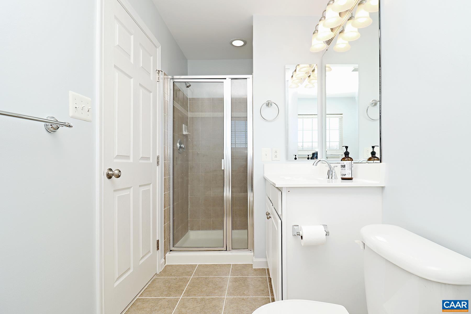 339 Rolkin Road Charlottesville, VA 22911 - Photo 11 of 22 a bathroom with a shower sink mirror and toilet