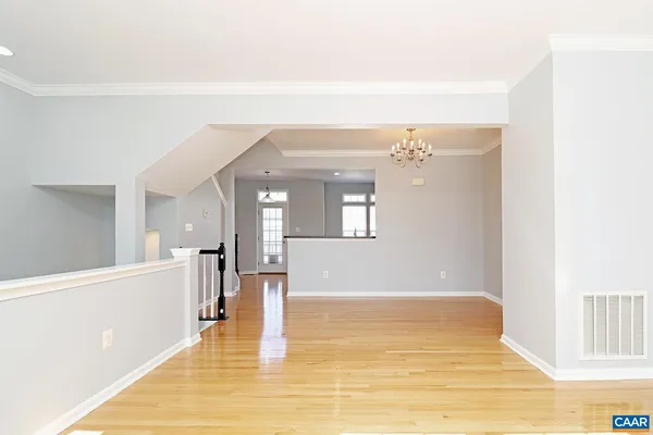 a view of empty room with wooden floor