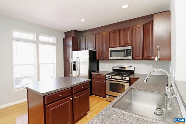 a kitchen with a refrigerator stove and microwave