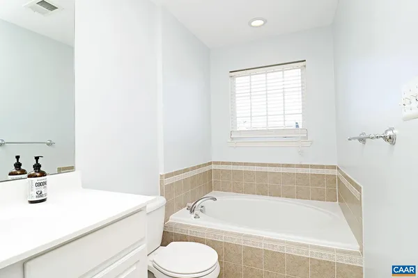 a white bath tub sitting next to a white sink