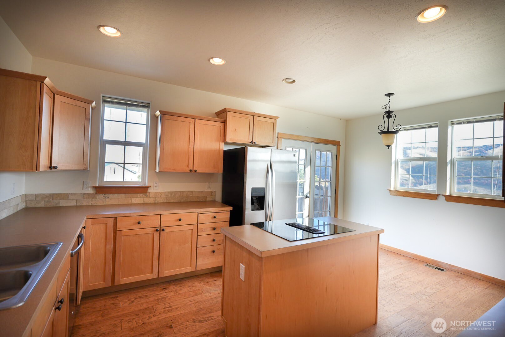 239 South Patit Road Dayton, WA 99328 - Photo 11 of 30 a kitchen with cabinets a sink and appliances