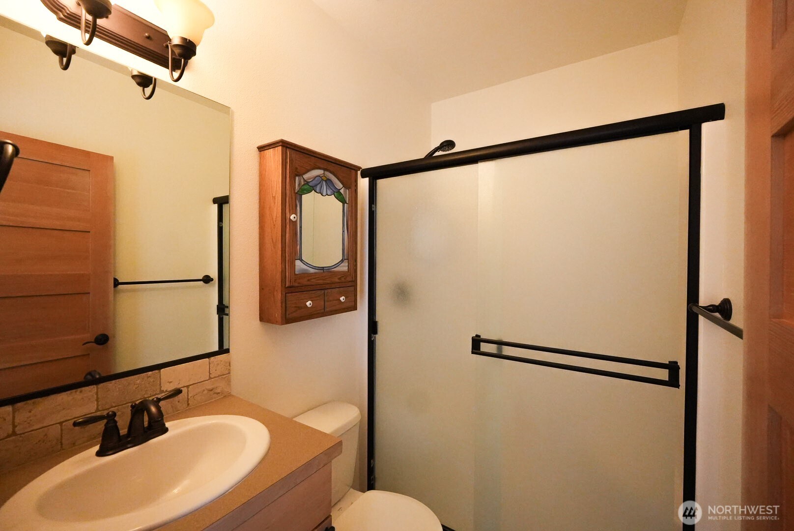 239 South Patit Road Dayton, WA 99328 - Photo 17 of 30 a bathroom with a sink mirror vanity and toilet