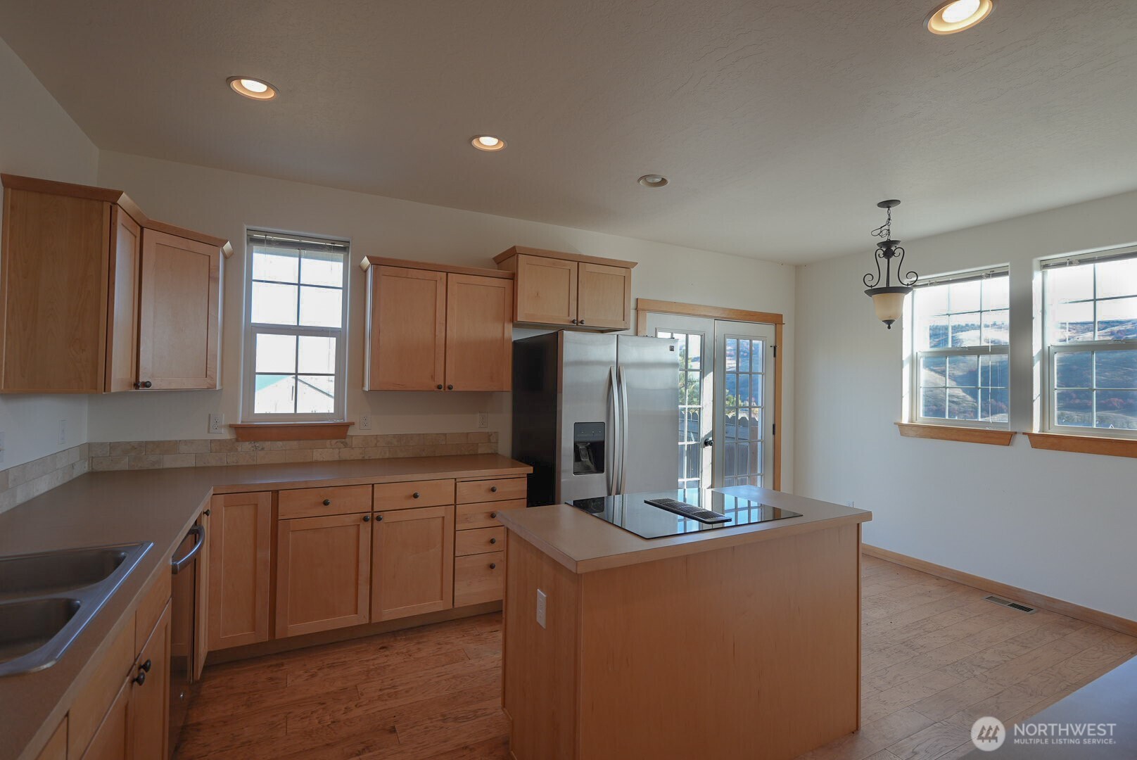 239 South Patit Road Dayton, WA 99328 - Photo 9 of 30 a kitchen with stainless steel appliances granite countertop a refrigerator and a stove top oven