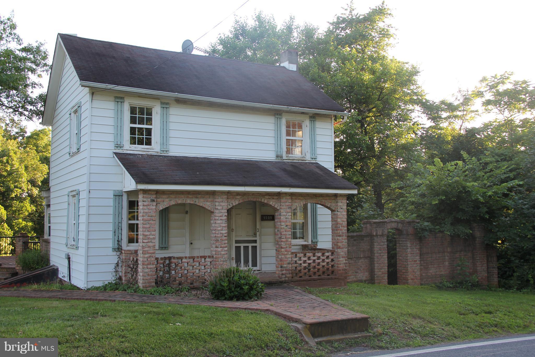 9509 Rocky Ridge Road Rocky Ridge, MD 21778 - Photo 1 of 25 a front view of a house with garden
