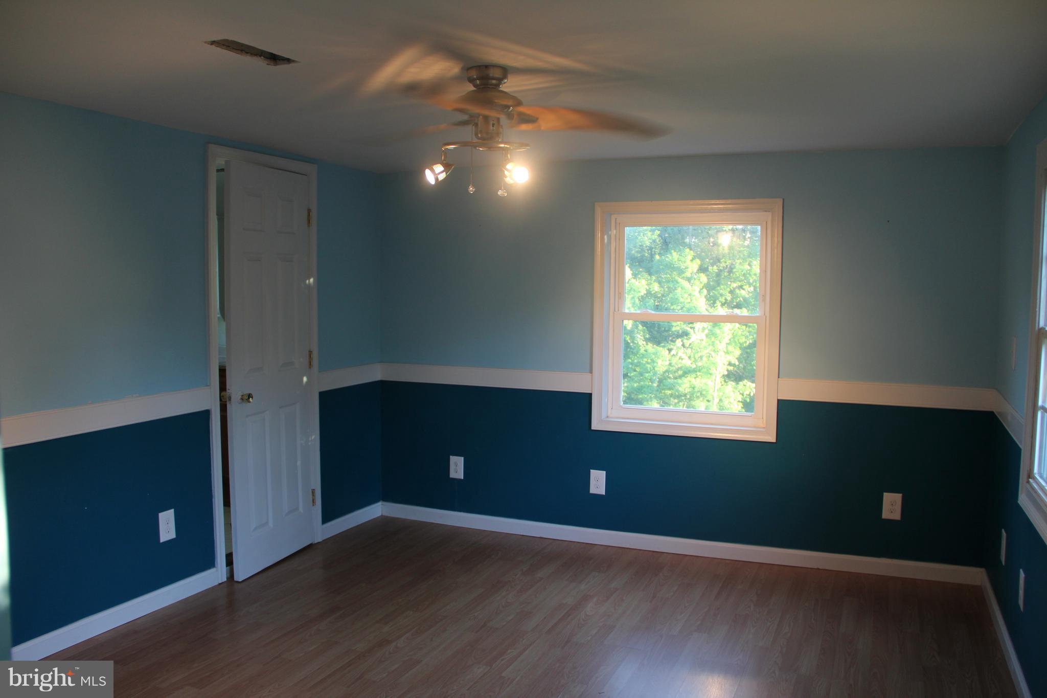 9509 Rocky Ridge Road Rocky Ridge, MD 21778 - Photo 16 of 25 a view of an empty room with wooden floor and windows