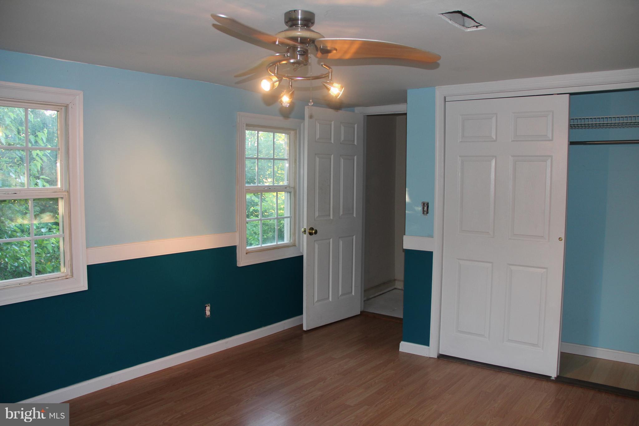 9509 Rocky Ridge Road Rocky Ridge, MD 21778 - Photo 17 of 25 an empty room with wooden floor closet and windows