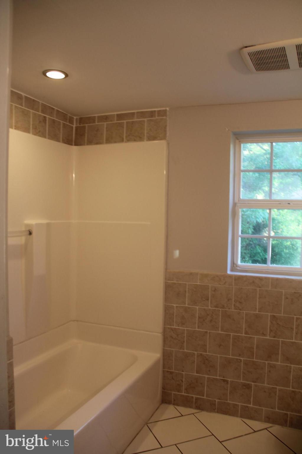 9509 Rocky Ridge Road Rocky Ridge, MD 21778 - Photo 19 of 25 a bathroom with a shower and a bathtub