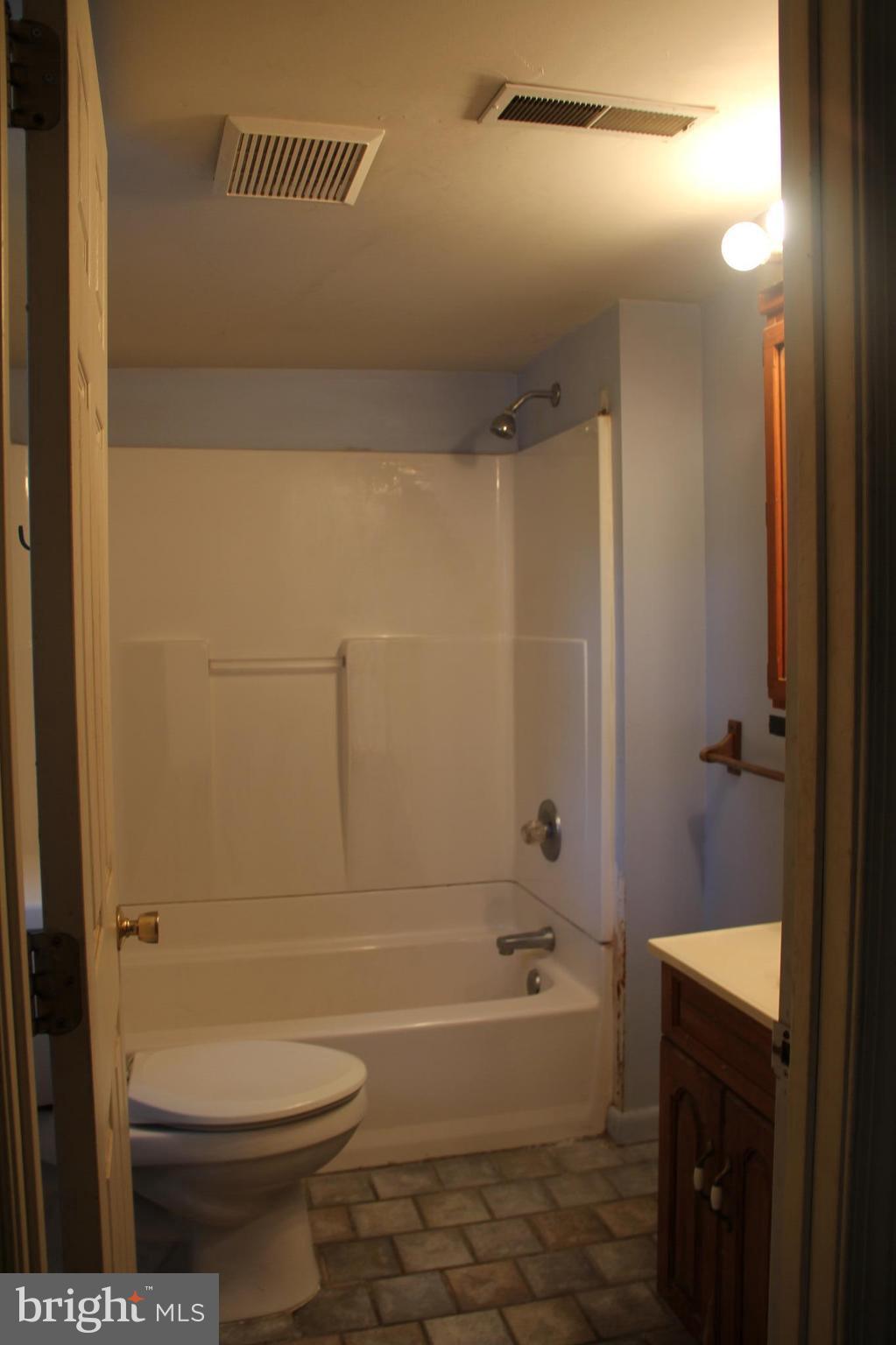 9509 Rocky Ridge Road Rocky Ridge, MD 21778 - Photo 22 of 25 a bathroom with a toilet and a bathtub