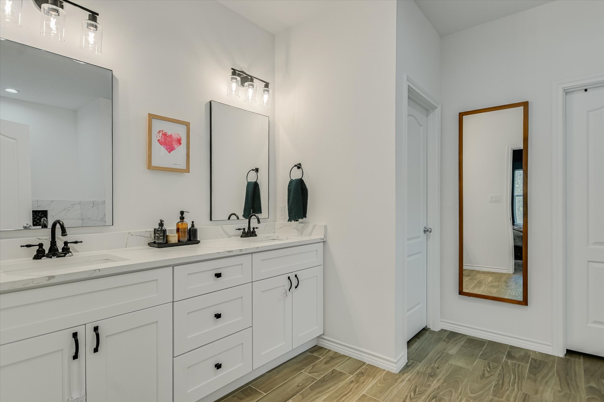 671 Shiloh Road Bastrop, TX 78602 - Photo 10 of 21 Spa-inspired primary bath with dual vanities, generous storage, and elegant finishes.