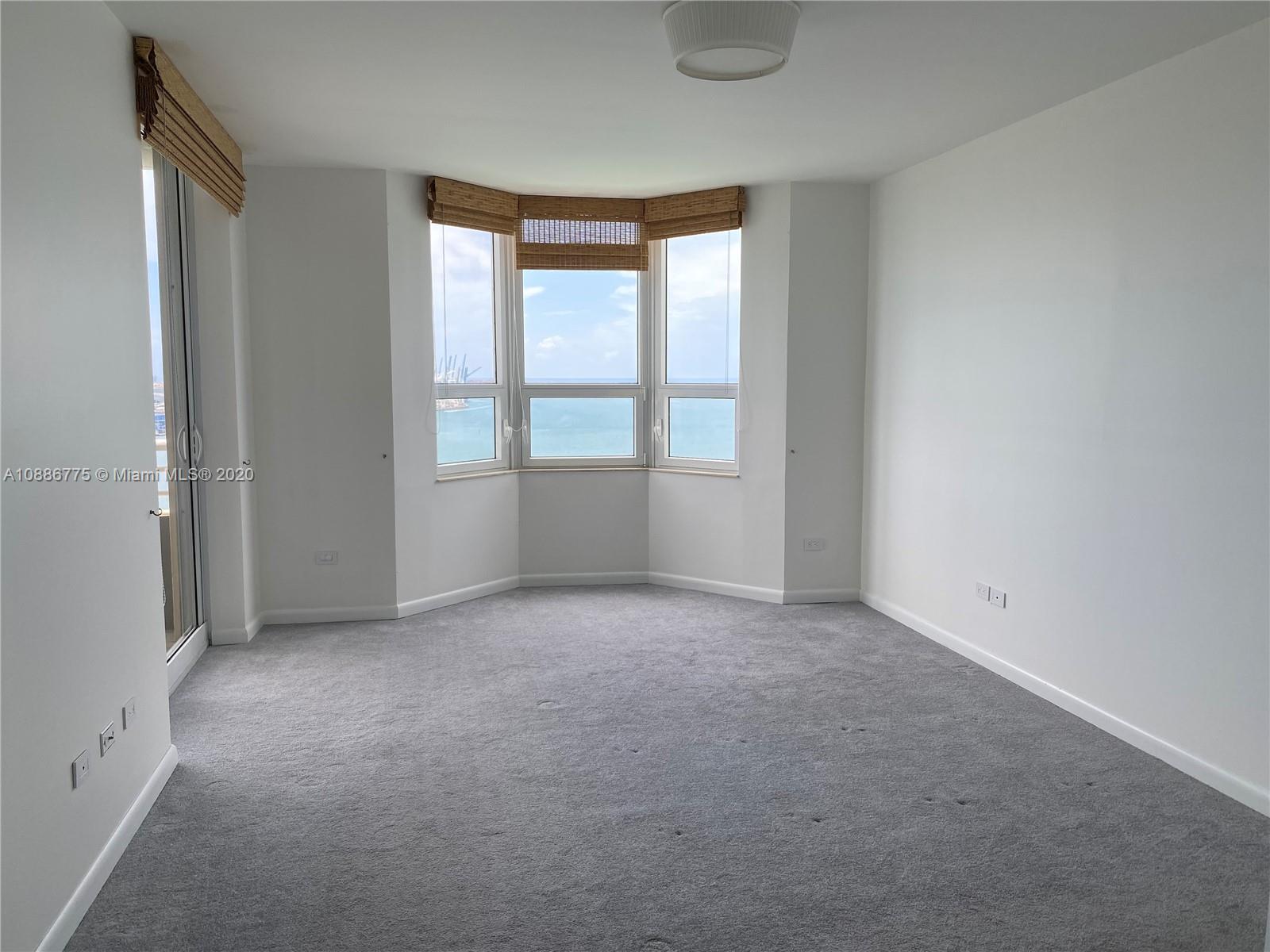 808 Brickell Key Drive, Unit 2601 Miami, FL 33131 - Photo 13 of 29 an empty room with windows