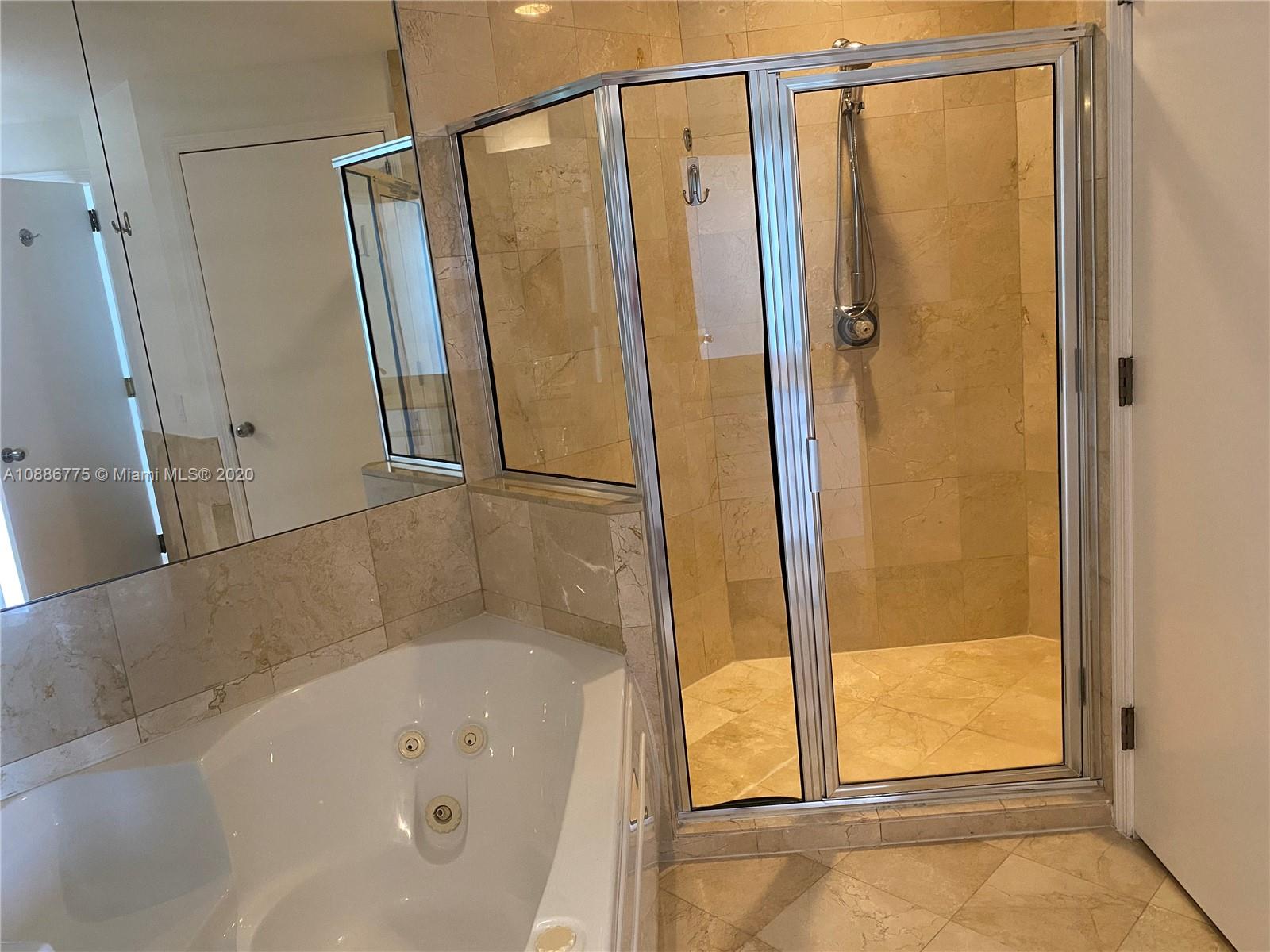 808 Brickell Key Drive, Unit 2601 Miami, FL 33131 - Photo 17 of 29 a bathroom with a bathtub and a shower