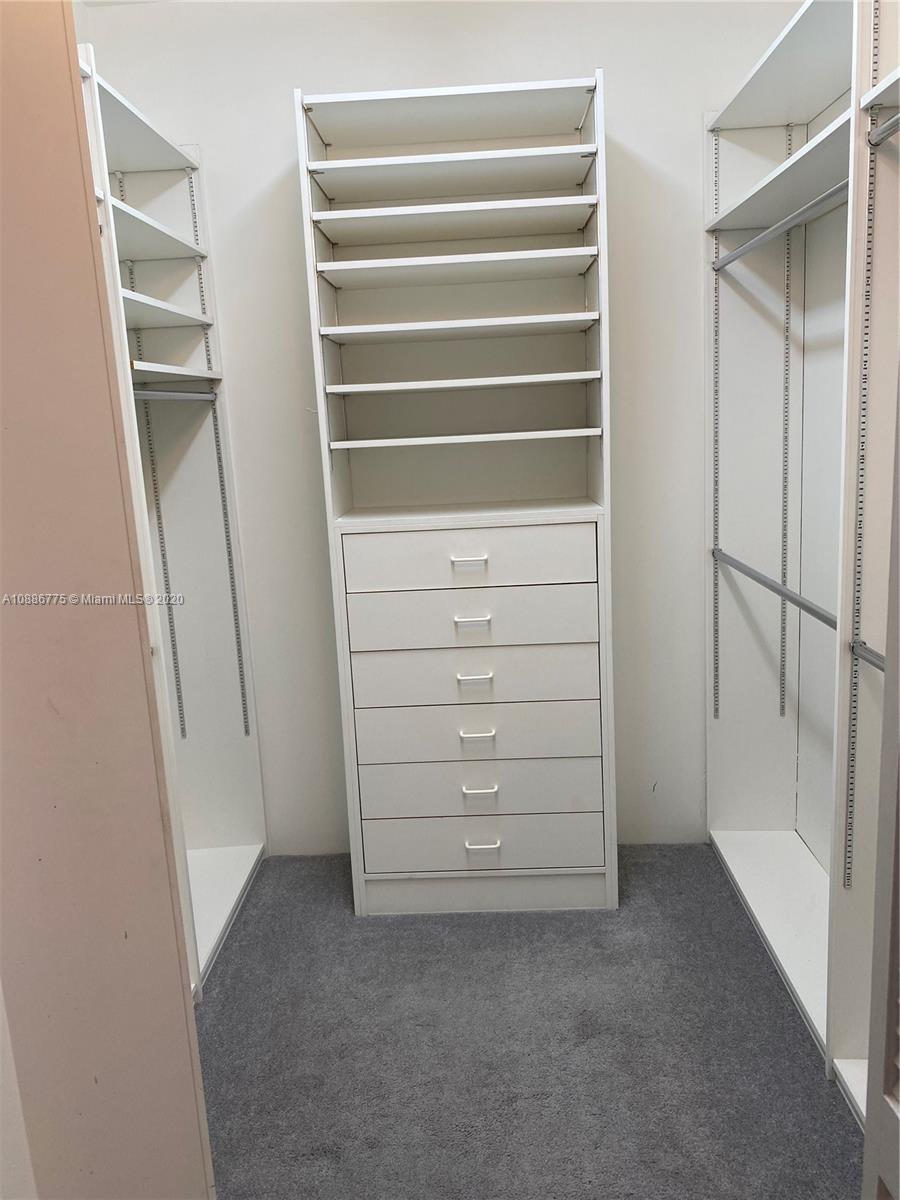 808 Brickell Key Drive, Unit 2601 Miami, FL 33131 - Photo 18 of 29 a view of walk in closet with empty racks