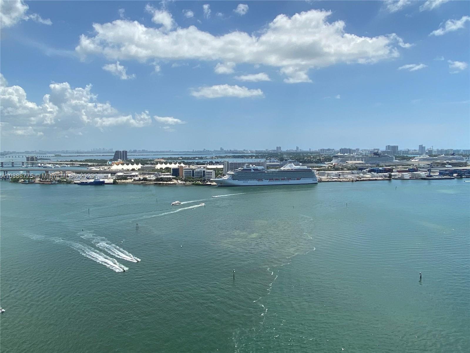 808 Brickell Key Drive, Unit 2601 Miami, FL 33131 - Photo 2 of 29 a view of a lake with houses in the back