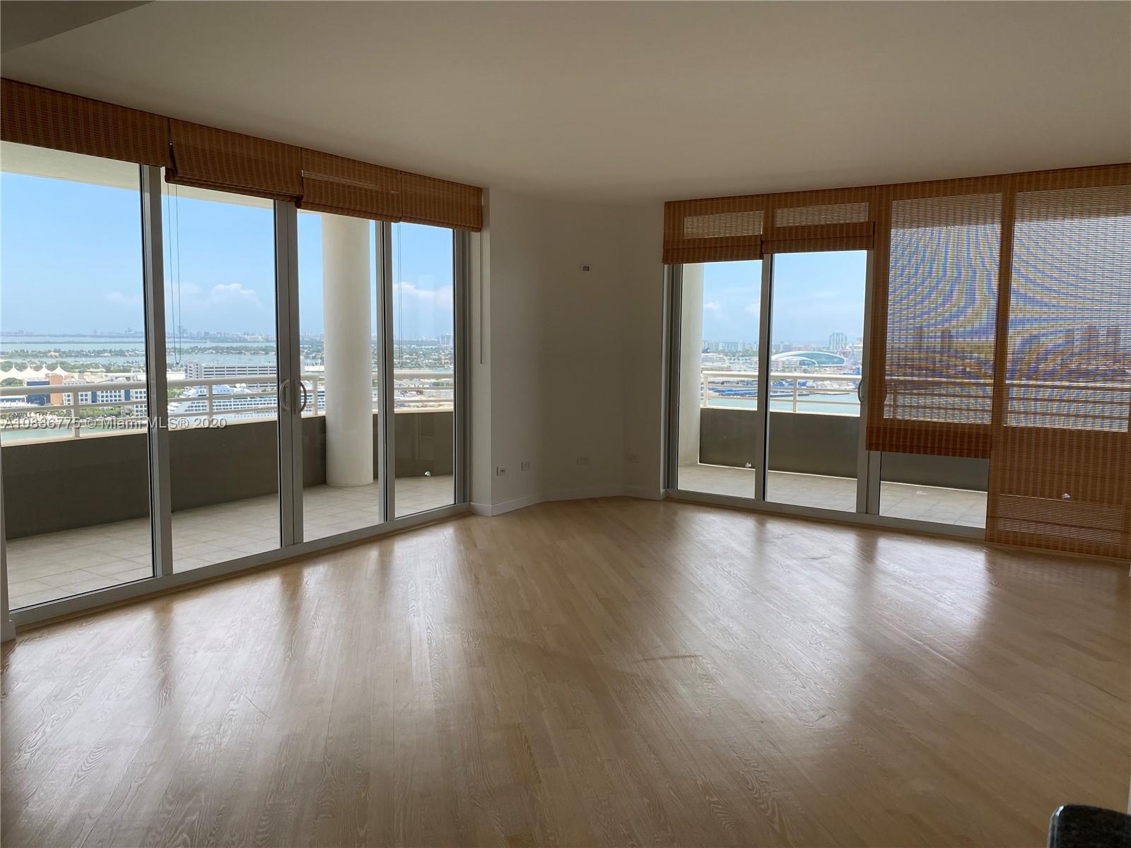 808 Brickell Key Drive, Unit 2601 Miami, FL 33131 - Photo 8 of 29 a view of an empty room with wooden floor and a window