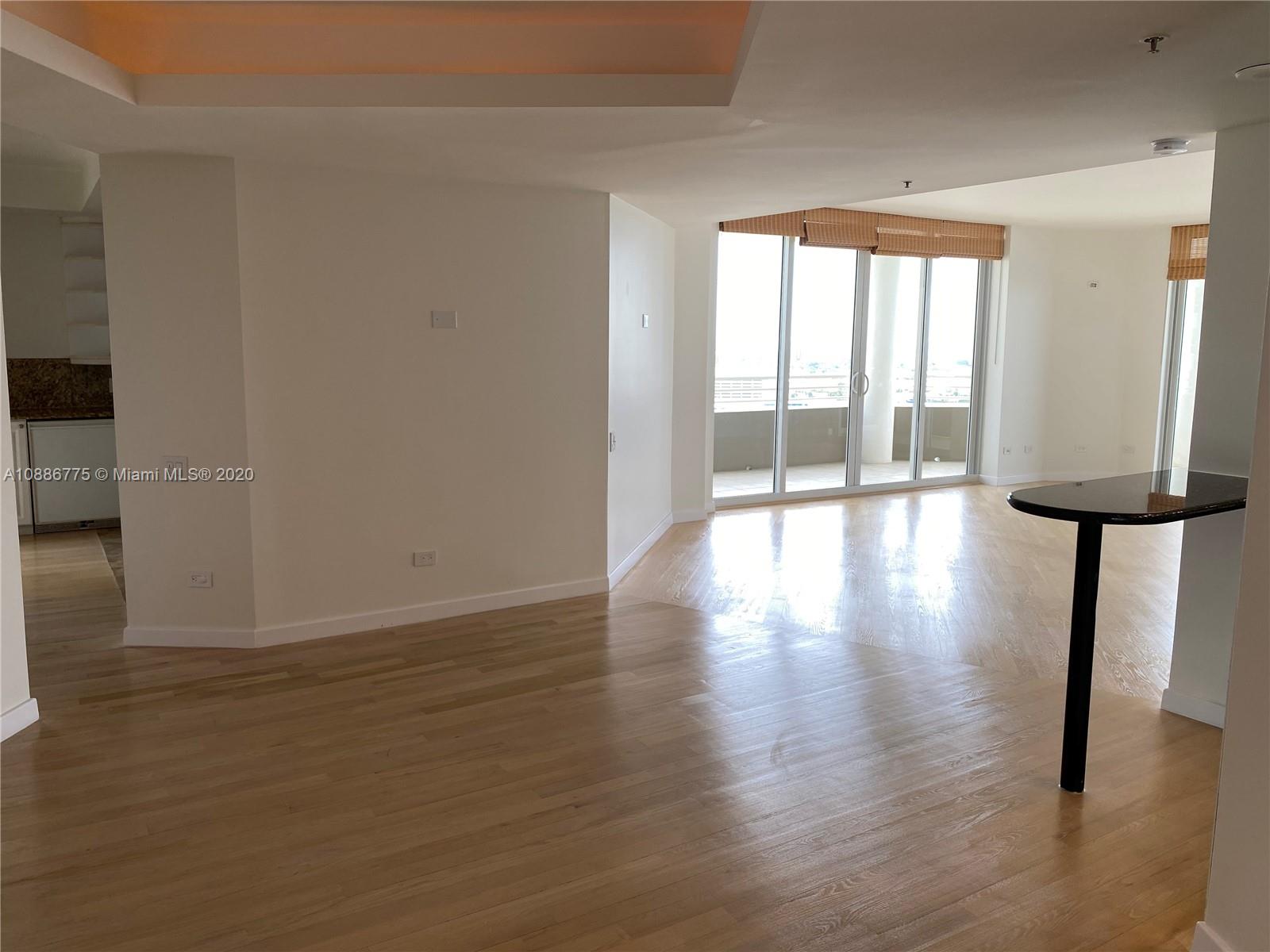 808 Brickell Key Drive, Unit 2601 Miami, FL 33131 - Photo 9 of 29 a view of an empty room with wooden floor and a window