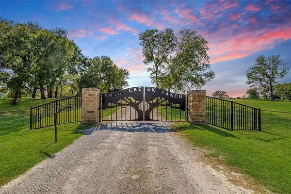 a view of a park with iron fence
