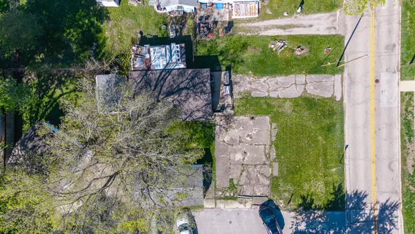 an aerial view of a house with a yard