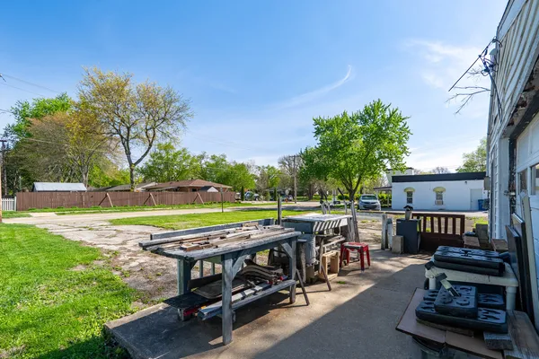 a view of a backyard with swimming pool and furniture
