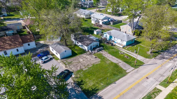 an aerial view of multiple houses with yard