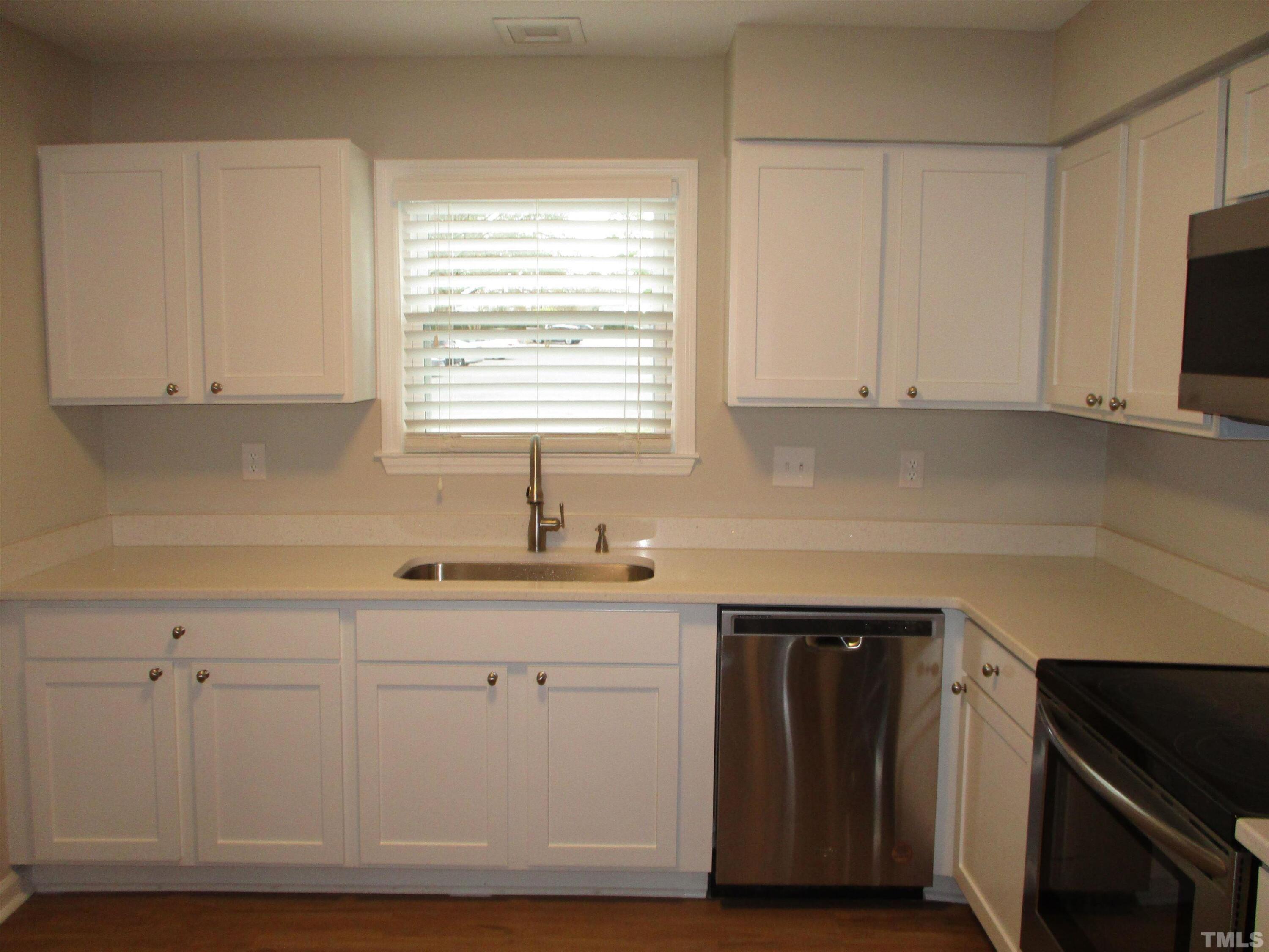 6435 New Market Way Raleigh, NC 27615 - Photo 3 of 17 a kitchen with granite countertop white cabinets and sink
