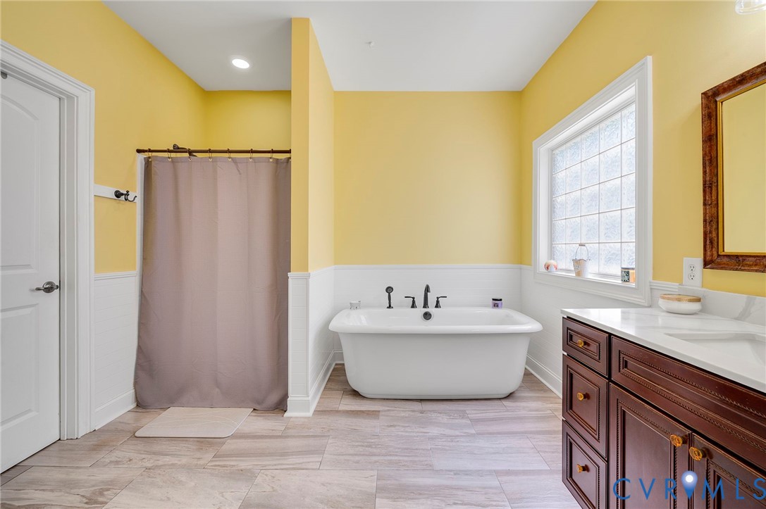 17170 Templeton Road Disputanta, VA 23842 - Photo 14 of 27 a bathroom with a tub sink and mirror