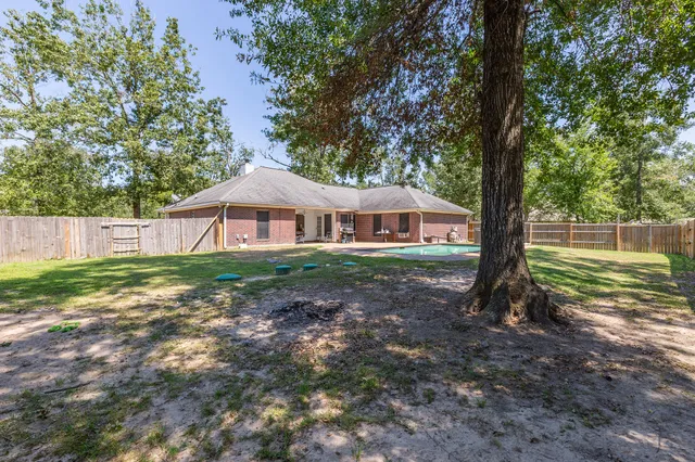 a front view of a house with swimming pool having outdoor seating