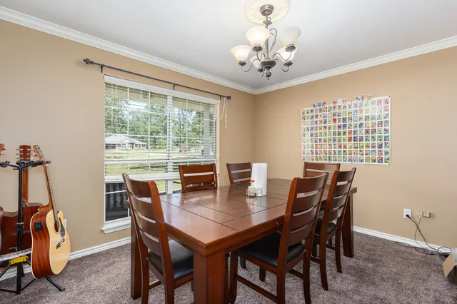 a reading room with furniture and a chandelier