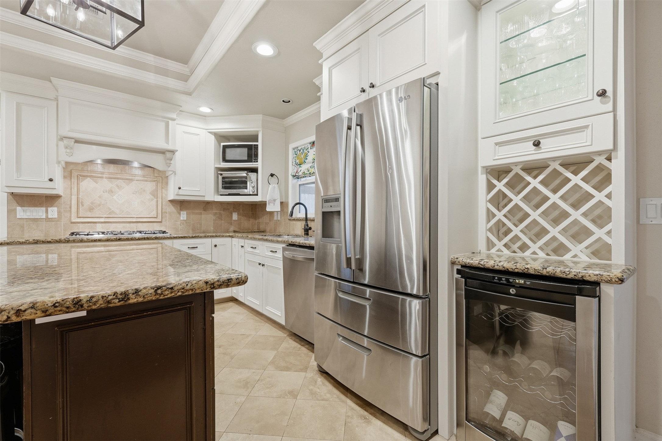 6236 Locke Lane Houston, TX 77057 - Photo 12 of 34 a kitchen with granite countertop stainless steel appliances and wooden cabinets