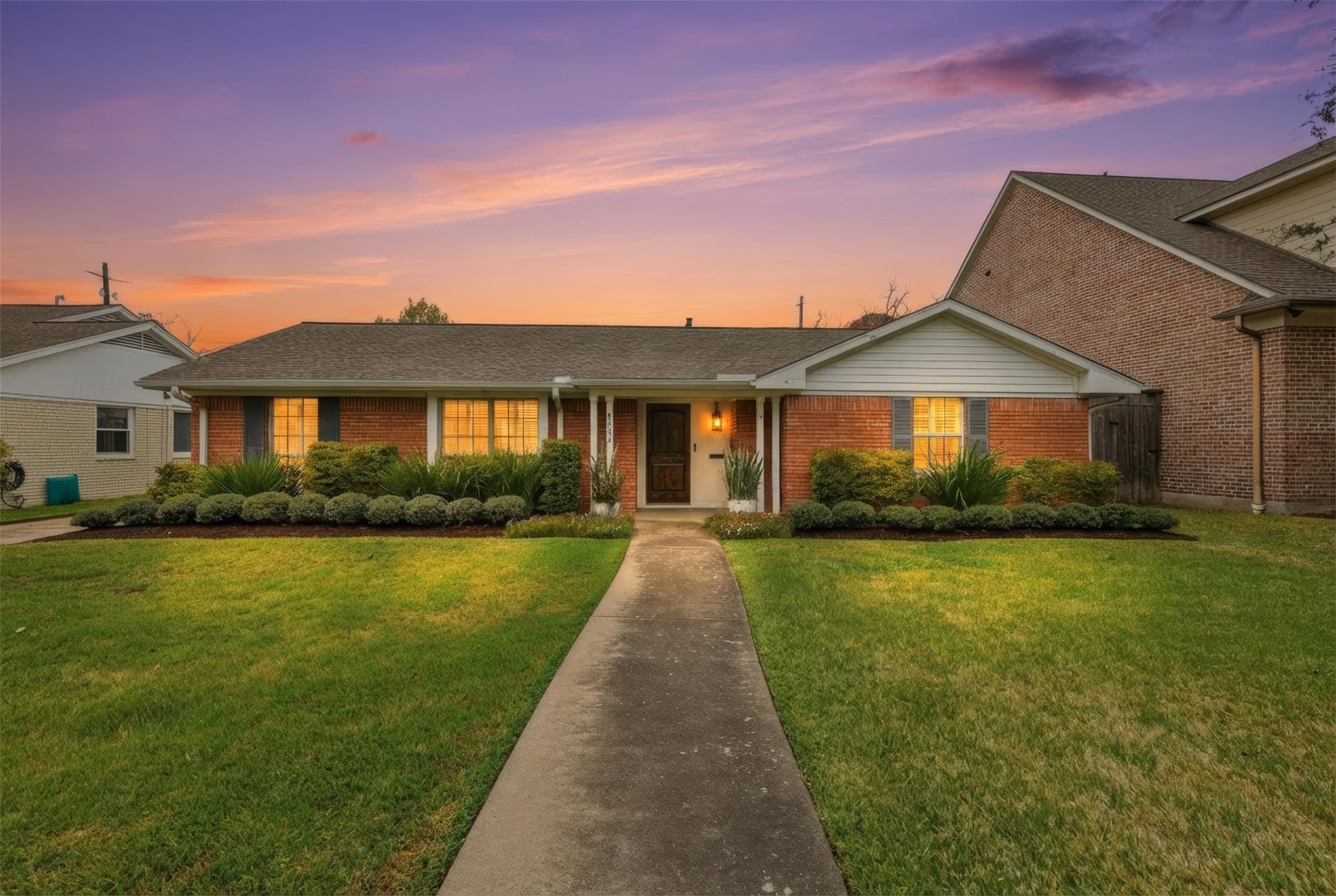 6236 Locke Lane Houston, TX 77057 - Photo 2 of 34 a front view of a house with yard and green space
