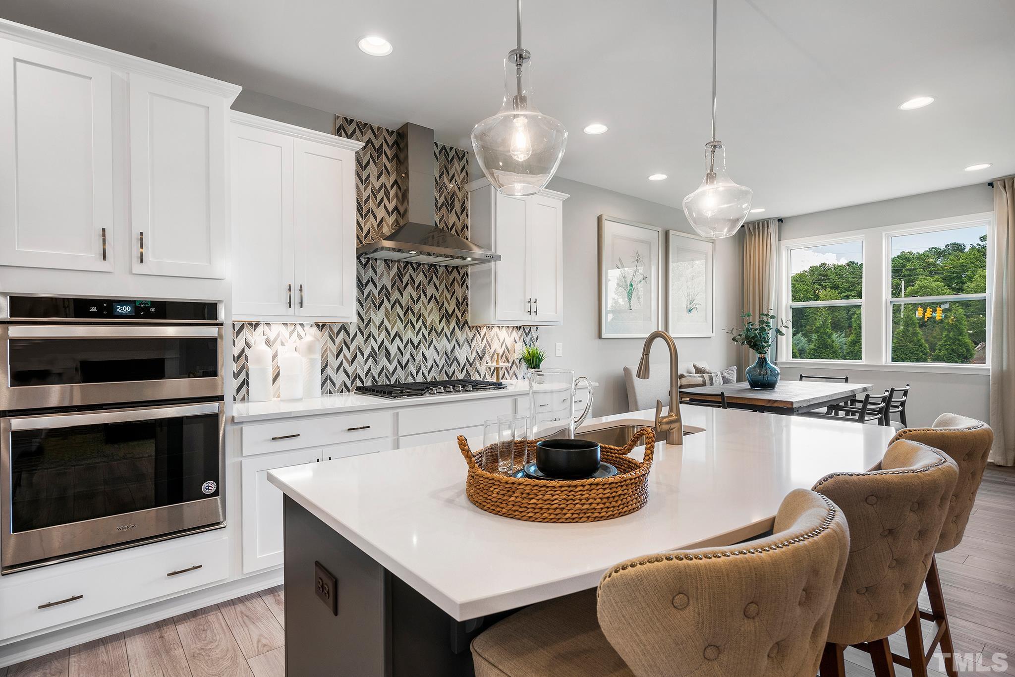 1016 Manchaca Loop, Unit 4 Apex, NC 27539 - Photo 1 of 36 a kitchen with stainless steel appliances granite countertop a sink a stove and a wooden floors