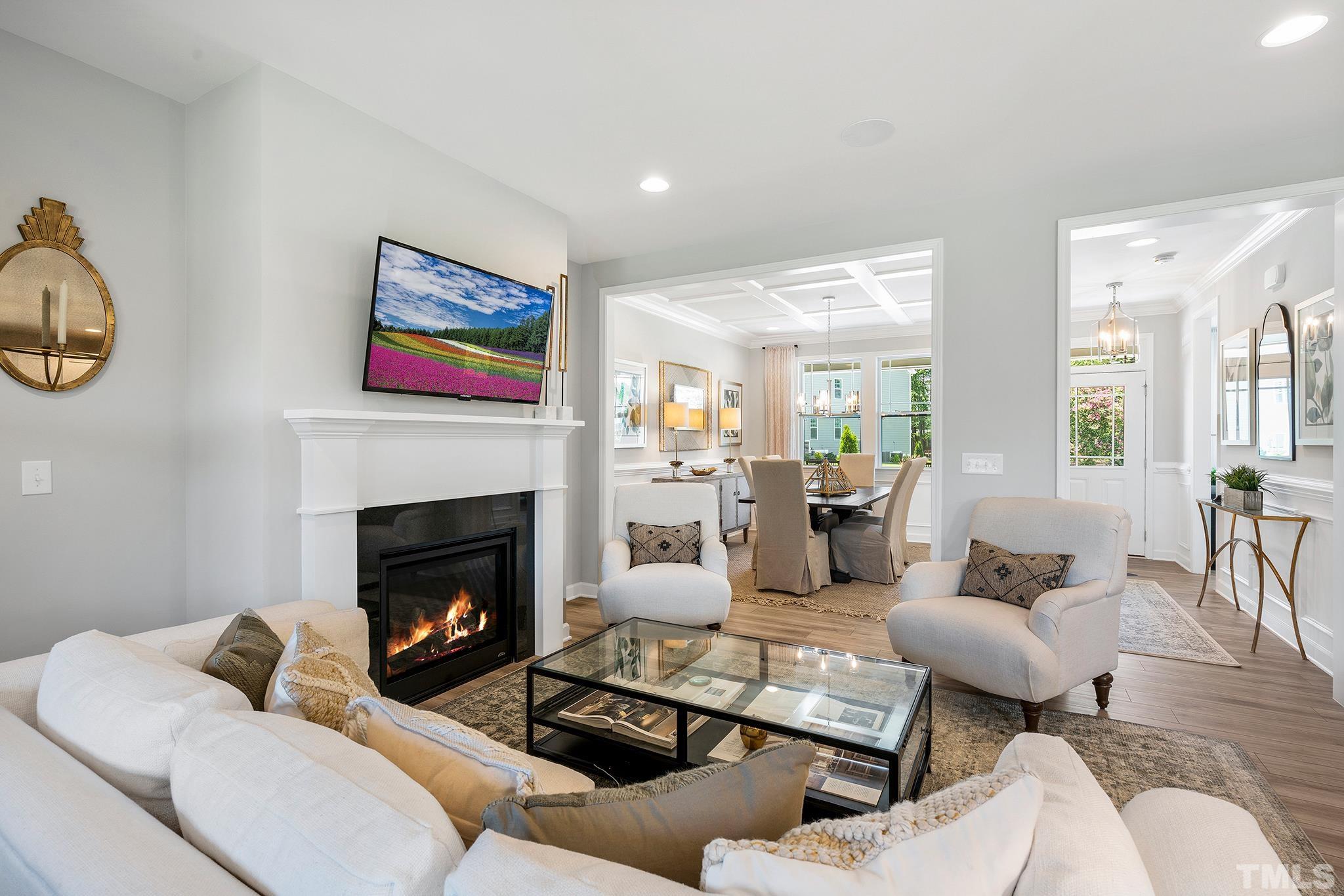 1016 Manchaca Loop, Unit 4 Apex, NC 27539 - Photo 12 of 36 a living room with furniture and a fireplace
