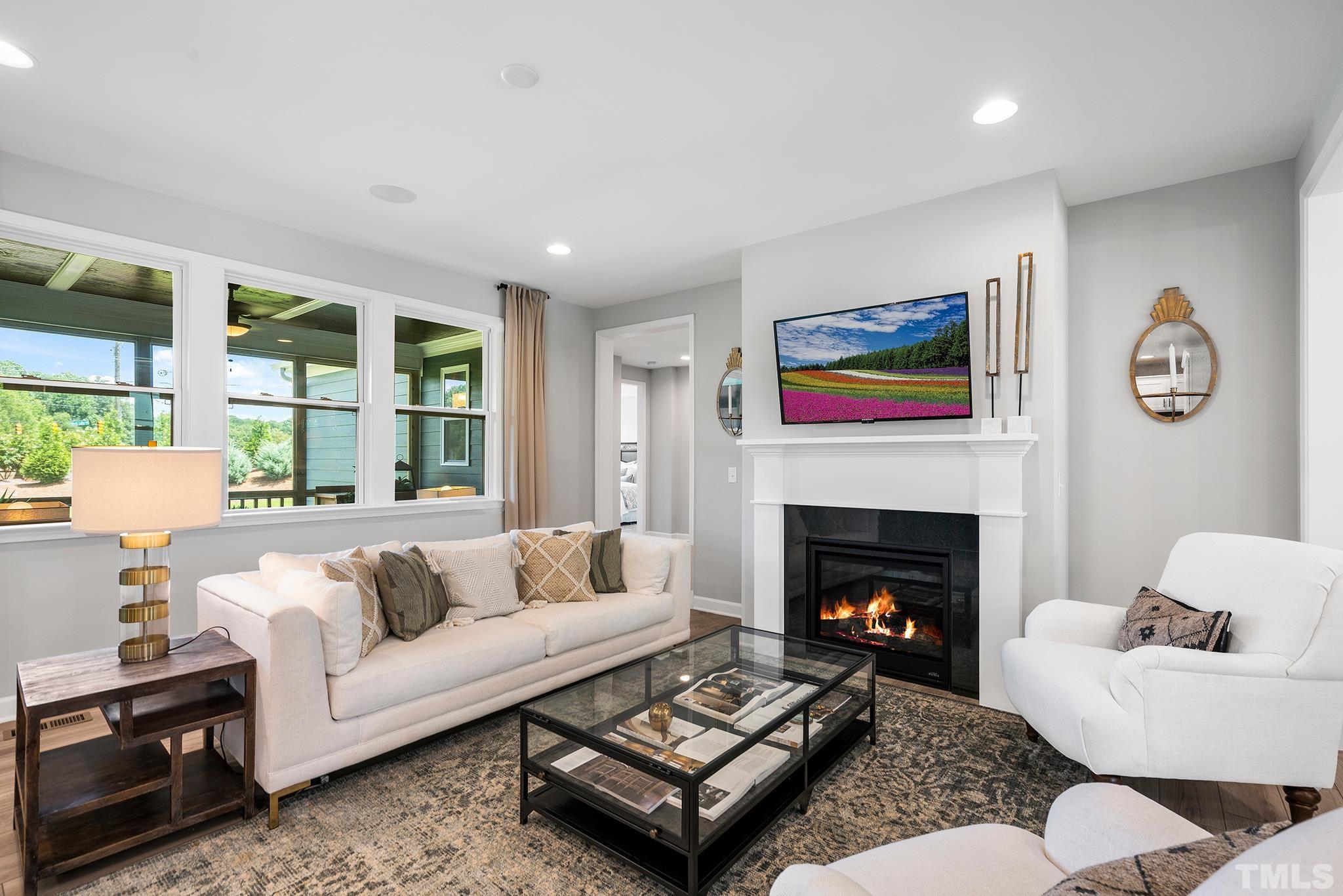 1016 Manchaca Loop, Unit 4 Apex, NC 27539 - Photo 14 of 36 a living room with furniture and a fireplace