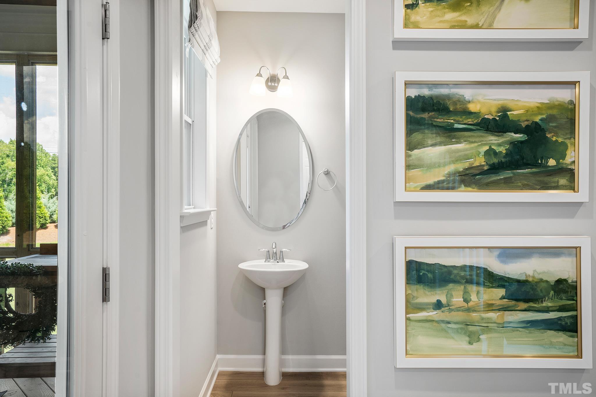 1016 Manchaca Loop, Unit 4 Apex, NC 27539 - Photo 16 of 36 a bathroom with a sink mirror and window