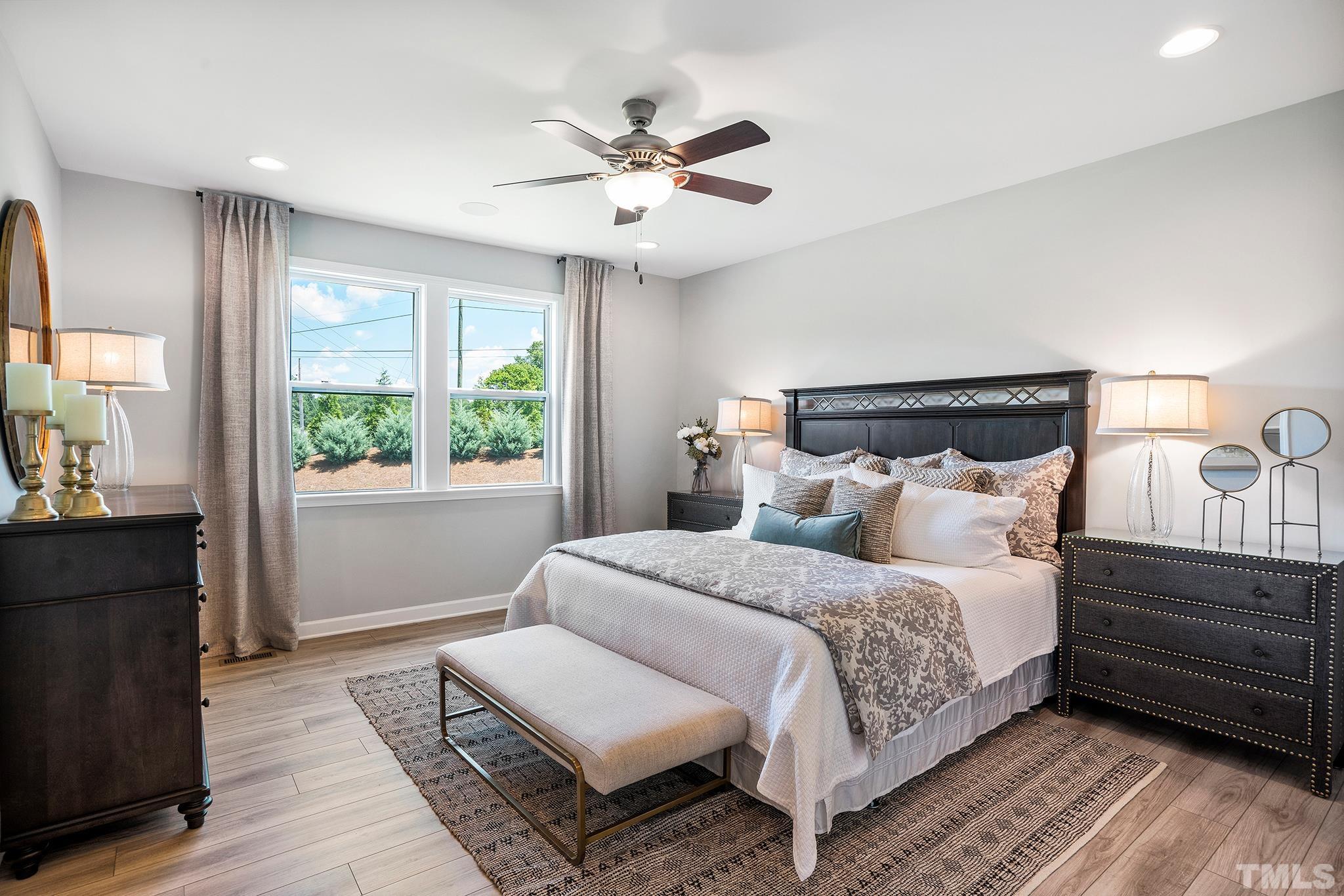 1016 Manchaca Loop, Unit 4 Apex, NC 27539 - Photo 19 of 36 a bedroom with a large bed and a window