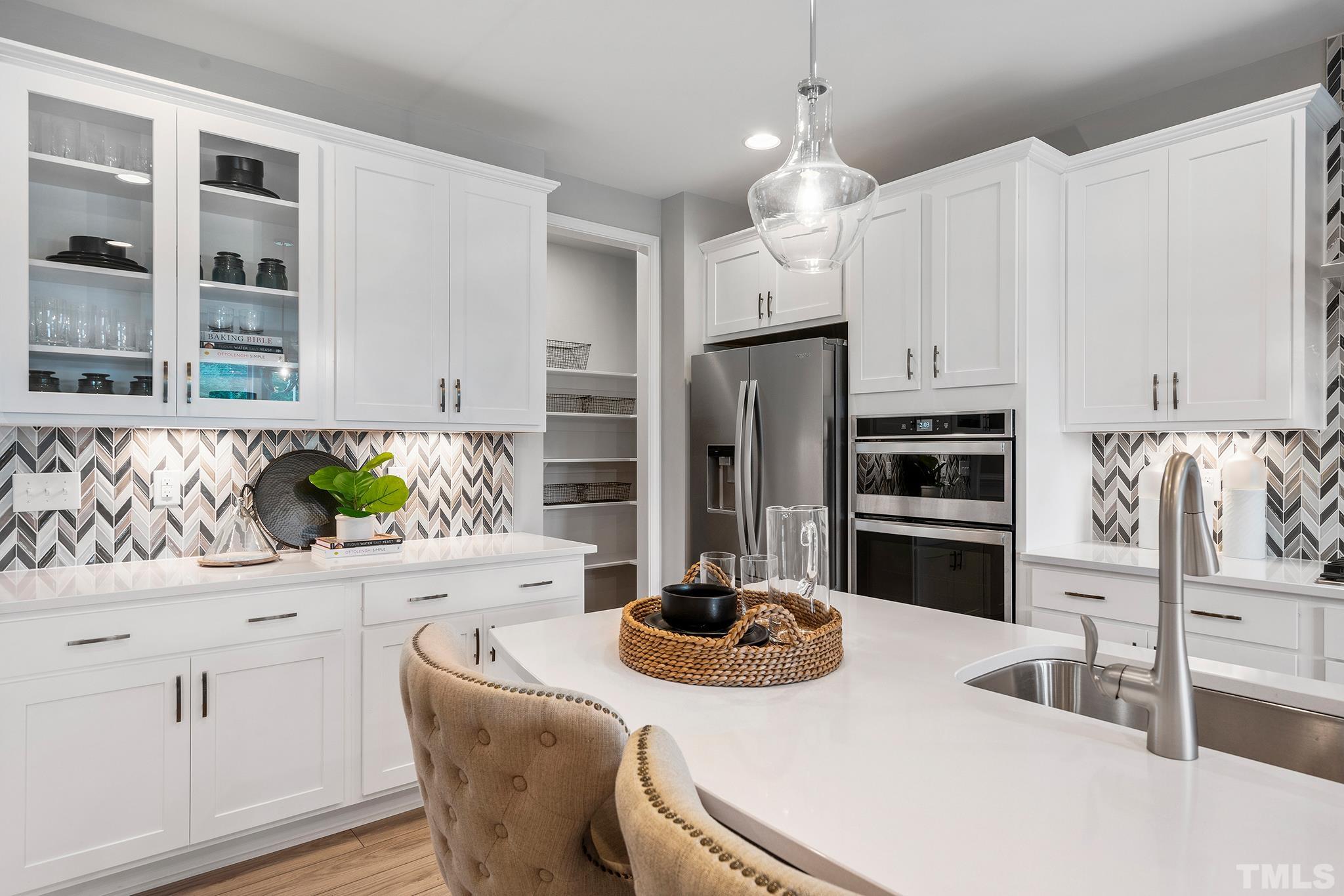 1016 Manchaca Loop, Unit 4 Apex, NC 27539 - Photo 2 of 36 a kitchen with stainless steel appliances kitchen island granite countertop a refrigerator and a sink
