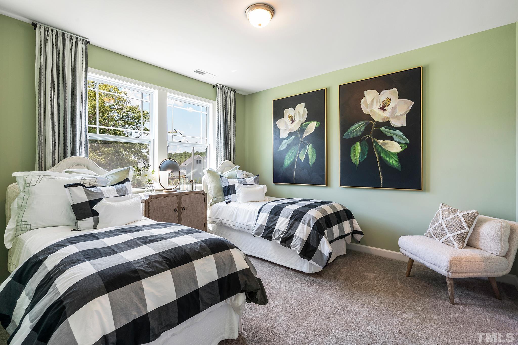 1016 Manchaca Loop, Unit 4 Apex, NC 27539 - Photo 27 of 36 a bedroom with two beds and a large window with outer view