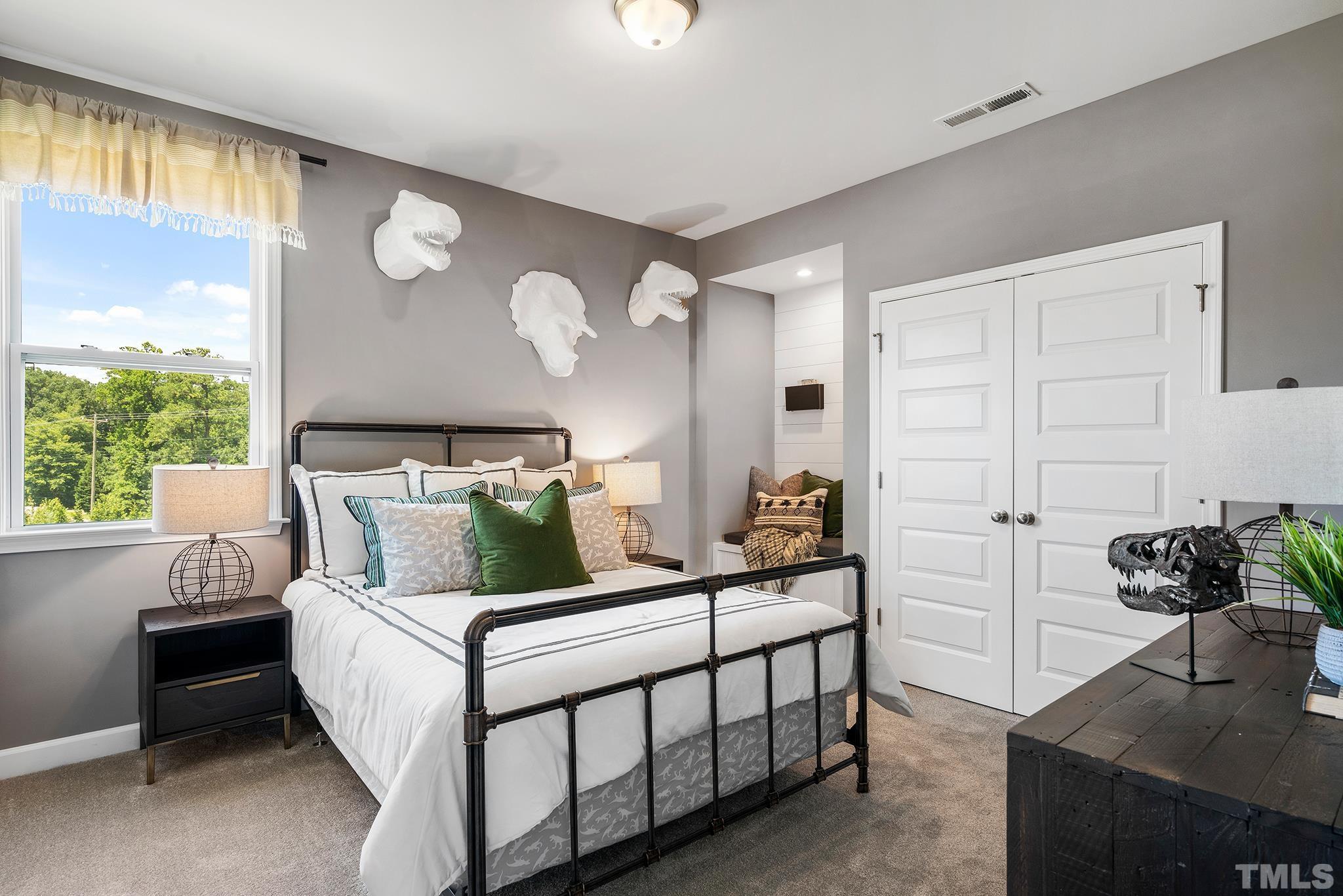 1016 Manchaca Loop, Unit 4 Apex, NC 27539 - Photo 28 of 36 a bedroom with a bed and a window